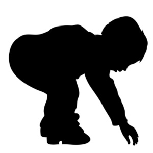 little boy exploring picking things up from the ground